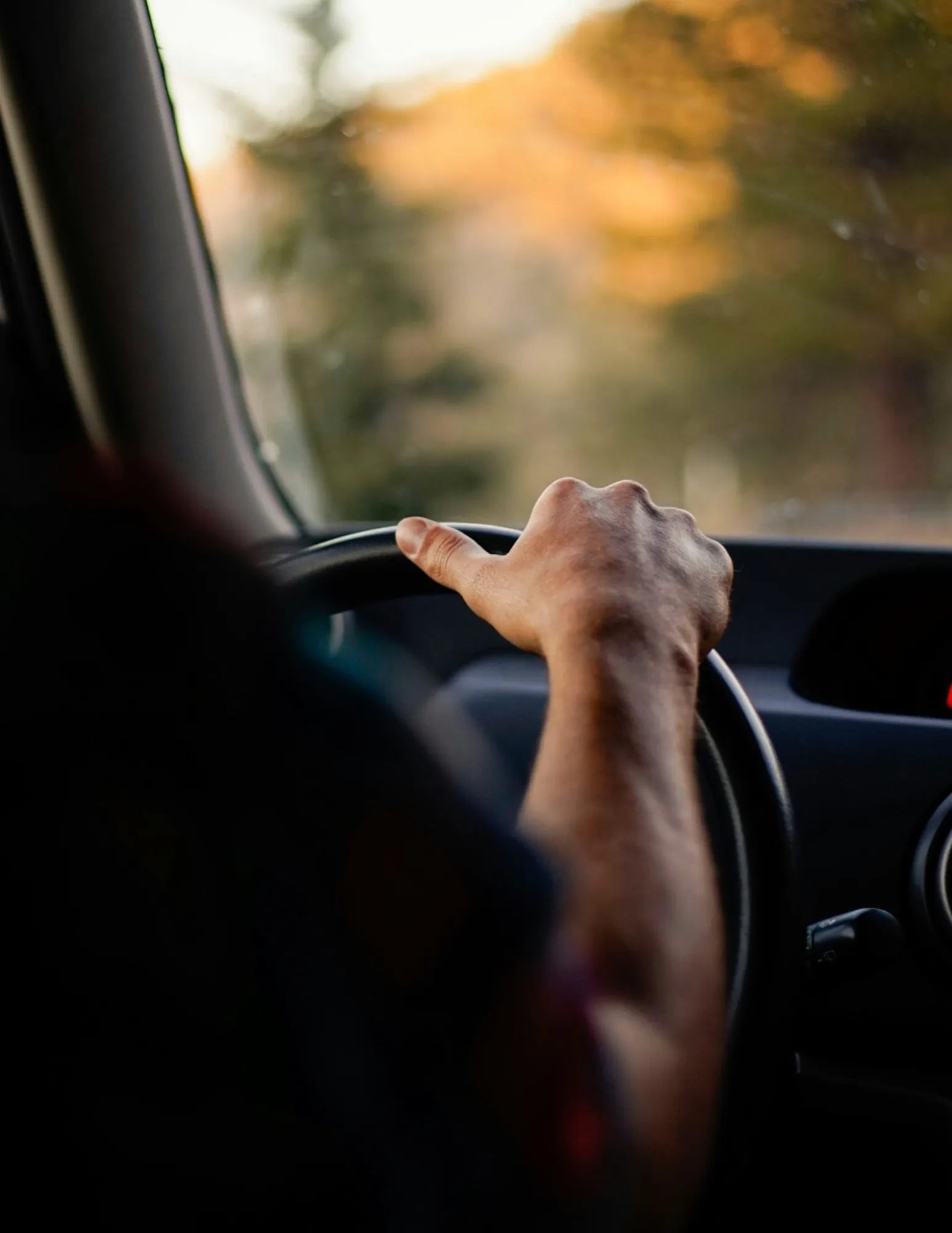 A hand on a steering wheel