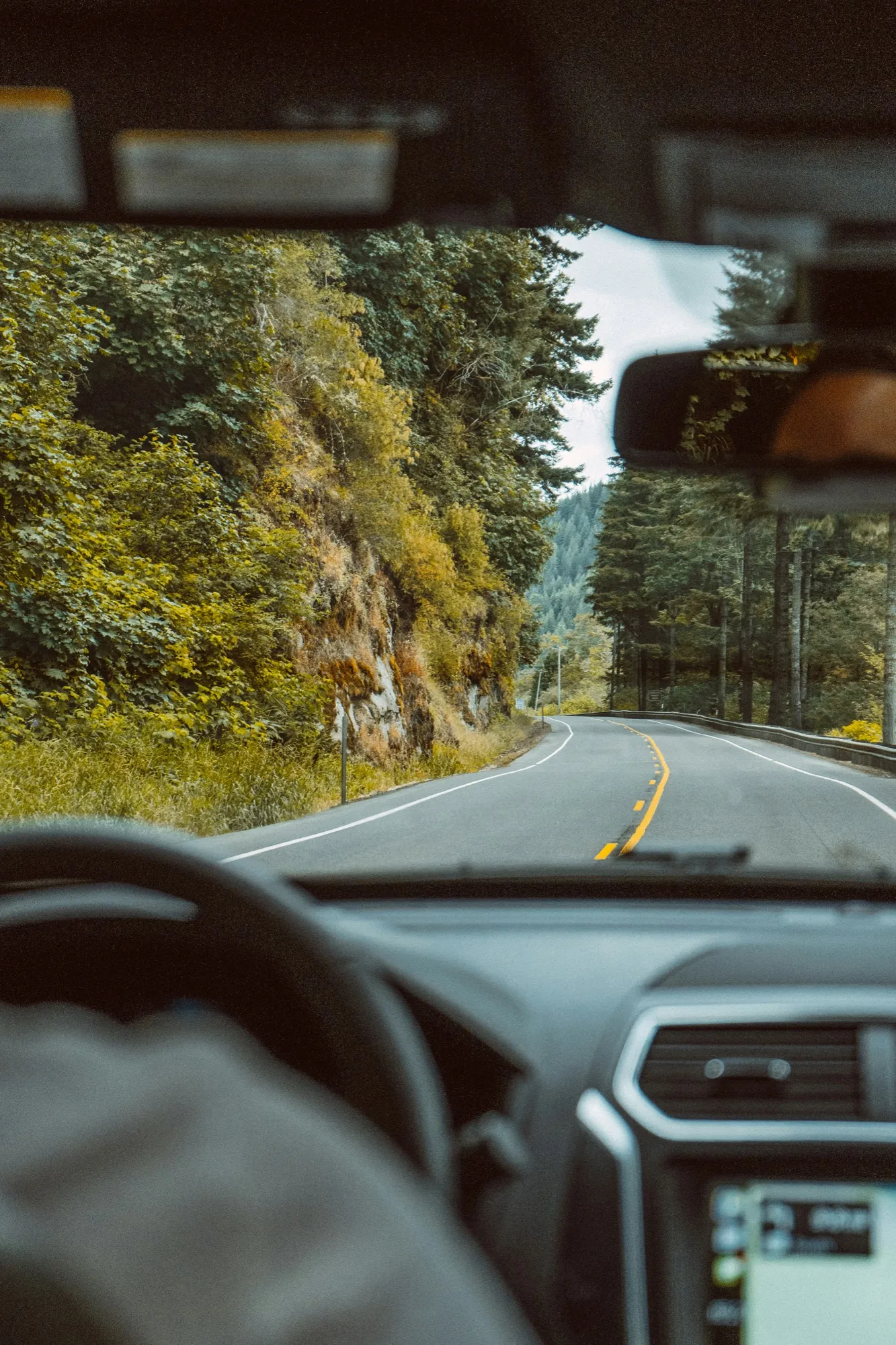 A winding road seen through a windshield