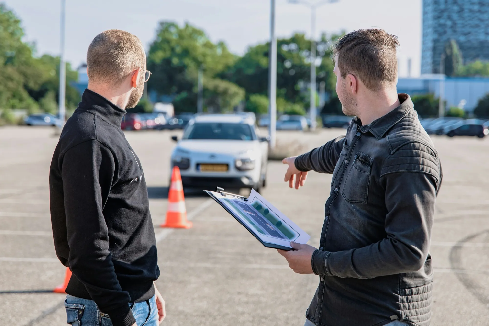 Driving skills being reviewed beside a vehicle
